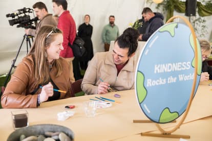 Attendees enjoying Earth Day event at Greenfield, painting rocks 